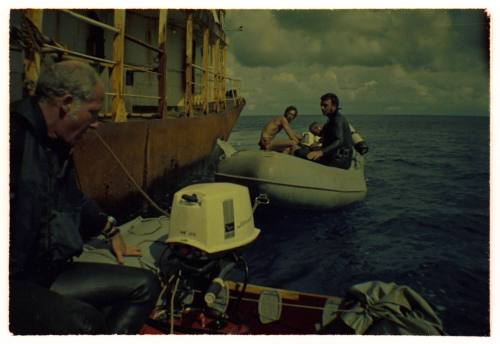 Two inflatable motorboats alongside a large vessel