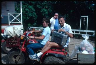 Ron Taylor on the back of a red three wheeled motorcycle