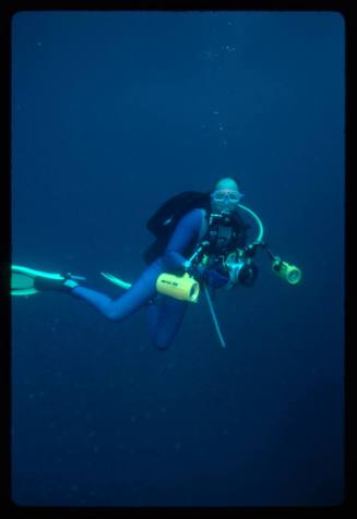 Diver underwater holding a camera