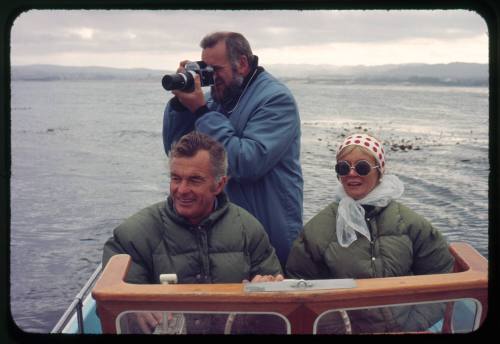 Valerie Taylor and two other men at the helm of a small vessel