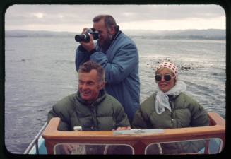 Valerie Taylor and two other men at the helm of a small vessel