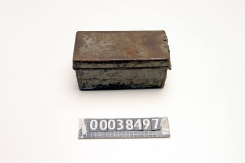 Tin box with gray paint used by ship plumber John Carrol to keep welding accessories