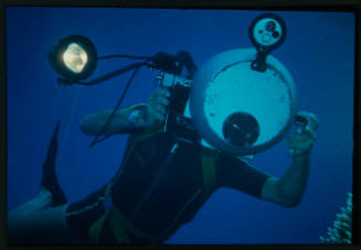 Diver holding a large underwater camera rig