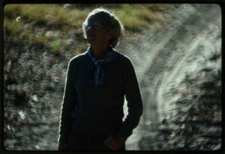 Photo of a lady backlit against a blurry background