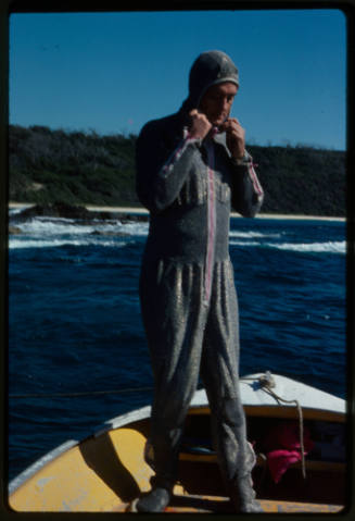 Ron Taylor putting on the chainmail suit (mesh suit)