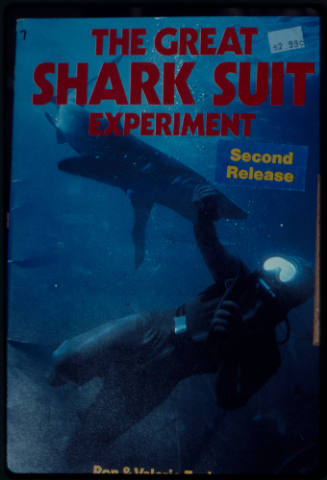 Magazine cover of scuba diver testing out the chainmail suit (mesh suit) in experiment using blue sharks 