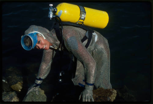 Behind the scenes image from the television feature, Operation Shark Bite, that documented Ron and Valerie Taylor testing the efficacy of the chainmail suit (mesh suit) against shark bites.  