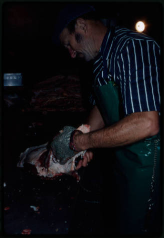 Man with a chainmail glove handling a carcass