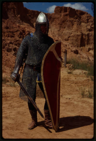 Person in medieval chainmail suit costume, part of the inspiration of Ron and Valerie Taylor's chainmail scuba diving suit used for working with wild animals underwater, namely sharks. 