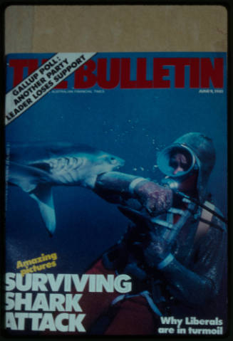 Magazine cover of scuba diver testing out the chainmail suit (mesh suit) in experiment using blue sharks 