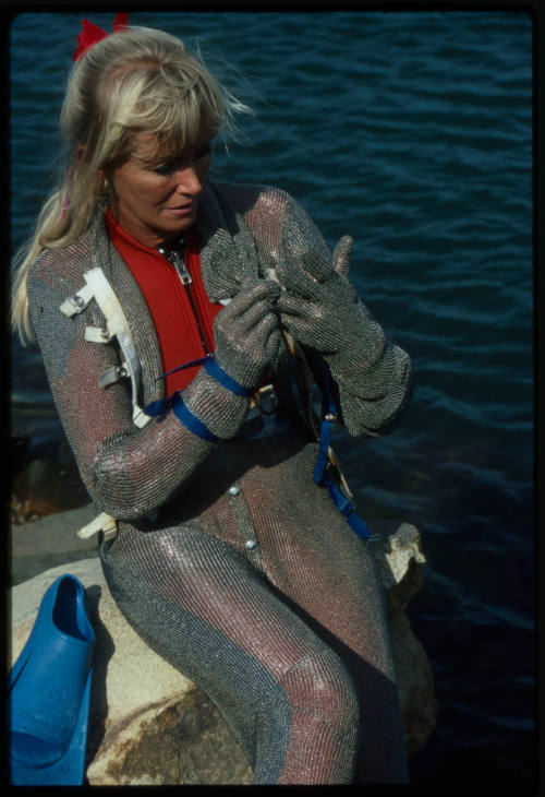 Behind the scenes image from the television feature, Operation Shark Bite, that documented Ron and Valerie Taylor testing the efficacy of the chainmail suit (mesh suit) against shark bites.  