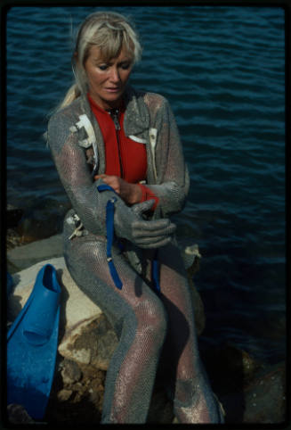 Behind the scenes image from the television feature, Operation Shark Bite, that documented Ron and Valerie Taylor testing the efficacy of the chainmail suit (mesh suit) against shark bites.  