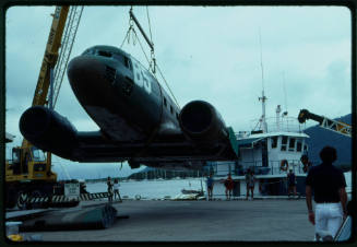 Prop plane from "Sky Pirates" being hoisted by crane