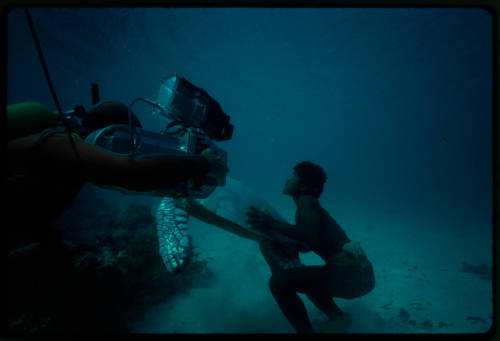 Diver filming person with turtle during filming of Silent One