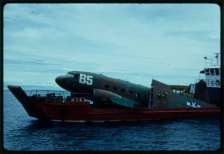 Prop plane for "Sky Pirates" being transported on a vessel