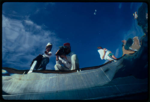 Photo shot from underwater of film crew at the waters edge