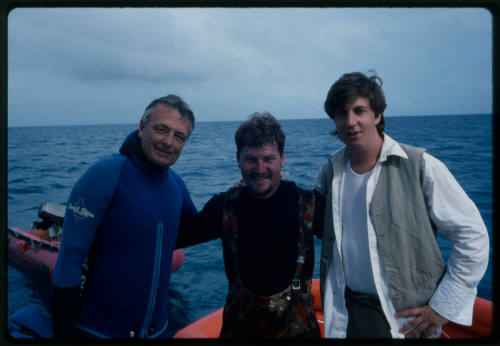 Ron Taylor posing with two other men