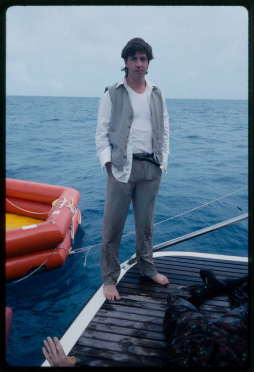 Full body shot of a man standing in front of a dummy