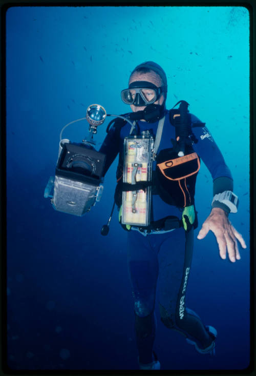 Ron Taylor swimming with underwater camera gear