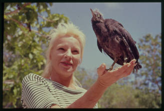 Valerie Taylor with a bird perched on her hand