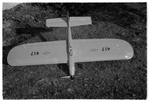 Top down view of a model plane resting on grass