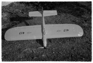 Top down view of a model plane resting on grass