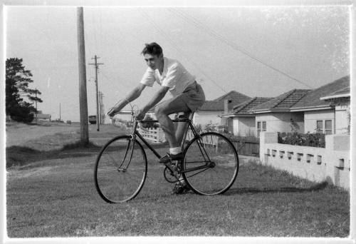 Man posing on a bike on the streetside