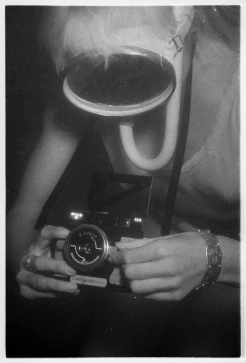 Black and white photo of Valerie Taylor holding an underwater camera