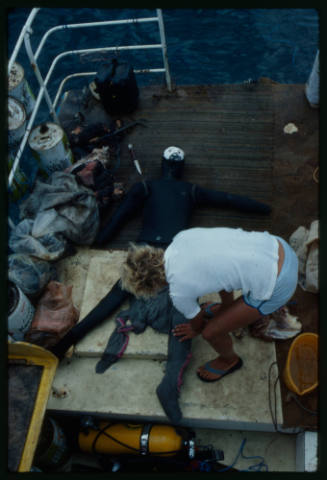 Mark Heighes preparing dummy for testing out the chainmail suit (mesh suit) in experiments with blue sharks and white sharks (great white sharks) before testing with a human