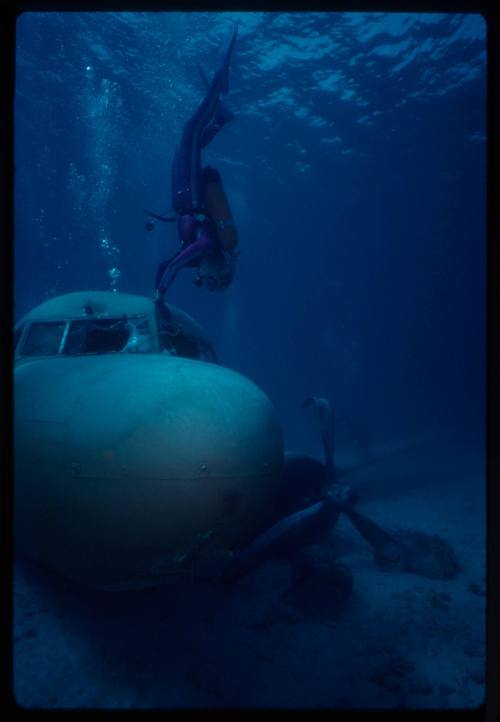 Valerie Taylor exploring submerged prop plan from the filming of "Sky Pirates"