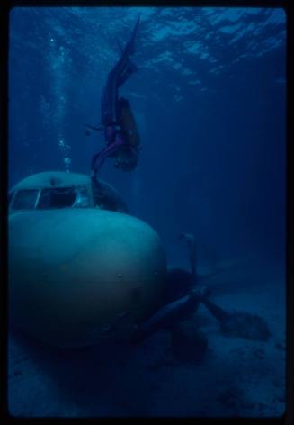 Valerie Taylor exploring submerged prop plan from the filming of "Sky Pirates"