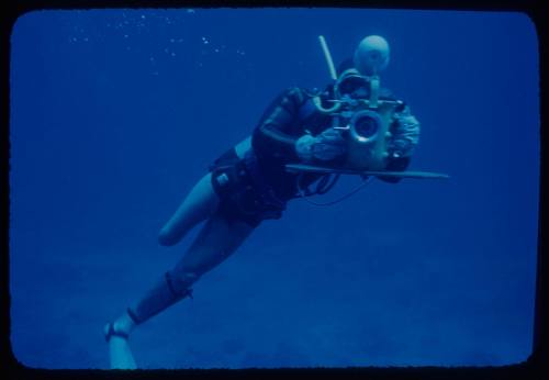 Diver swimming with an underwater camera