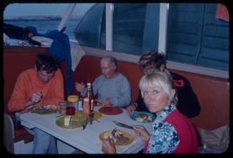 Valerie Taylor sharing a meal on a boat with crew from "Jaws"