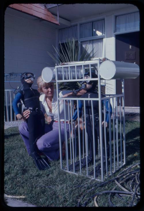 Valerie Taylor with small scale prop shark cages used in the filming of "Jaws"