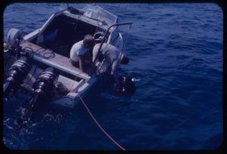 Crew preparing to lower shark cage during filming of "Jaws"