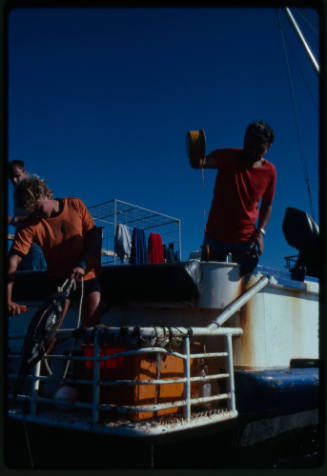 People on a boat preparing bait