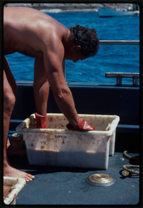 Man preparing bait on a boat