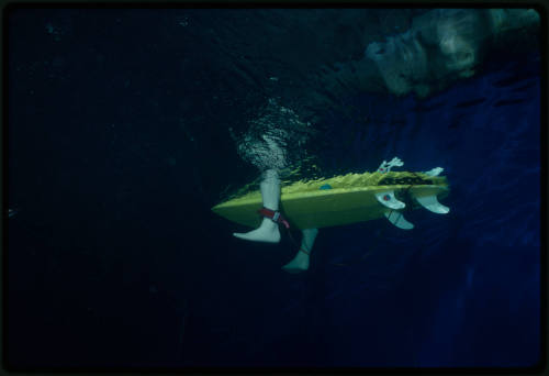 Underwater shot of a surfboard with model feet attached to its sides