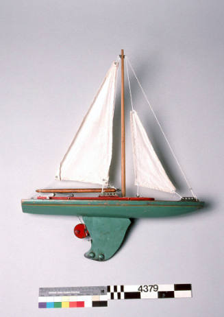 Toy yacht with green hull