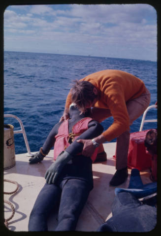 Testing out the chainmail suit (mesh suit) using a dummy in experiments with blue sharks and white sharks (great white sharks) before testing with a human 
