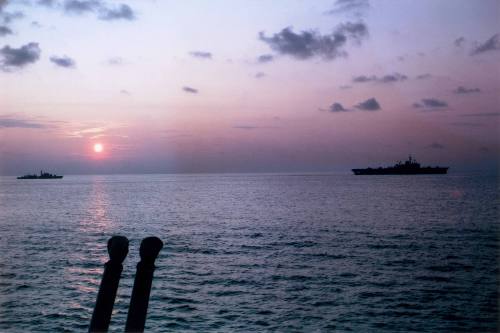 HMAS VAMPIRE and HMAS MELBOURNE at sea during sunrise