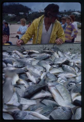 Man with a load of caught fish