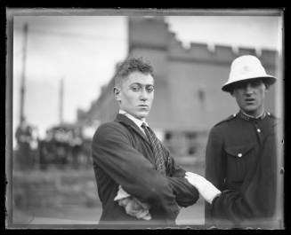 Injured man with a policeman at Fort Macquarie after GREYCLIFFE disaster