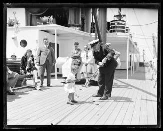 Ship's captain playing a deck game with a child