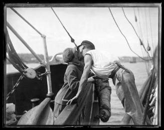 Man and woman kissing across two vessels