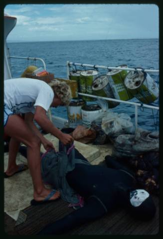 Mark Heighes preparing dummy for testing out the chainmail suit (mesh suit) in experiments with blue sharks and white sharks (great white sharks) before testing with a human 