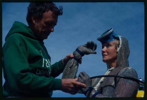 Valerie Taylor in mesh suit with Ron Taylor assisting her