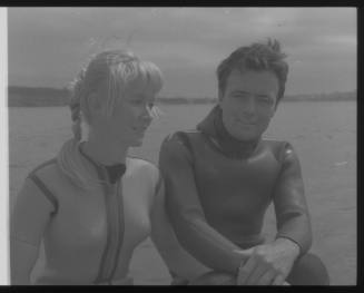 Medium shot of Valerie and Ron Taylor in wetsuits on board boat at sea