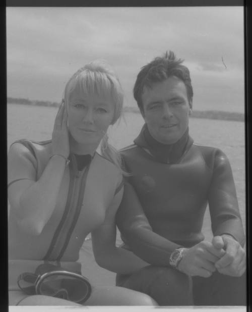 Medium shot of Valerie and Ron Taylor in wetsuits on board boat at sea