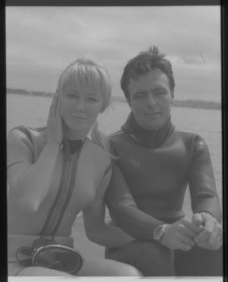 Medium shot of Valerie and Ron Taylor in wetsuits on board boat at sea